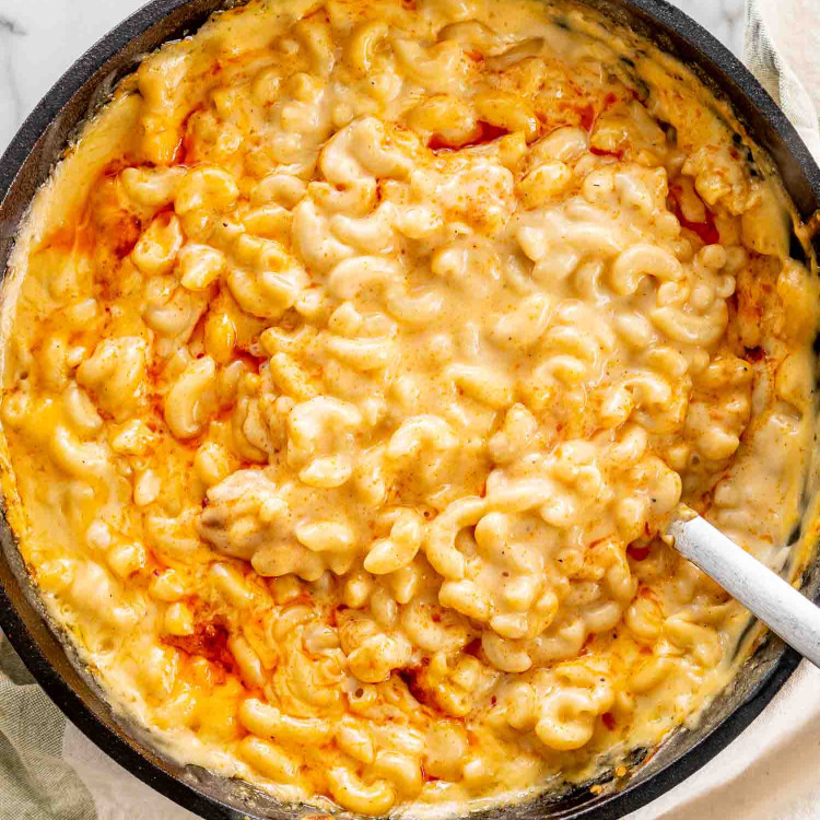 baked mac and cheese in a black cast iron skillet.