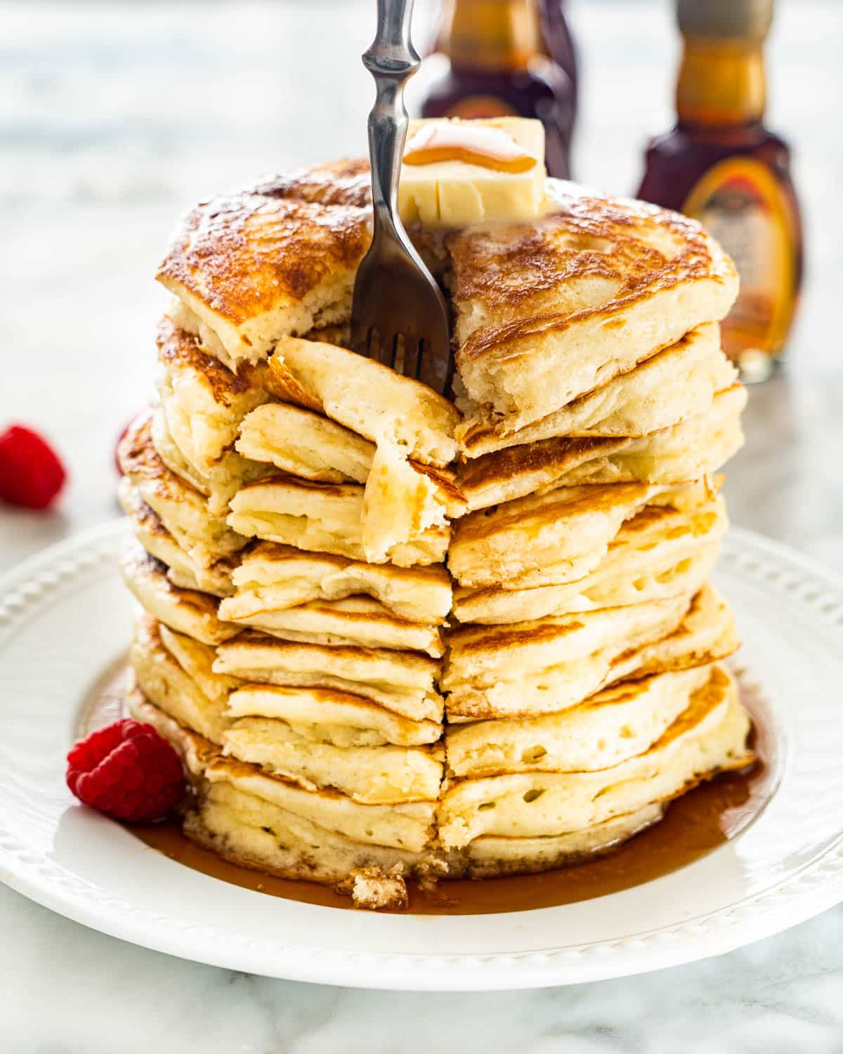 inserting a fork into a stack of pancakes