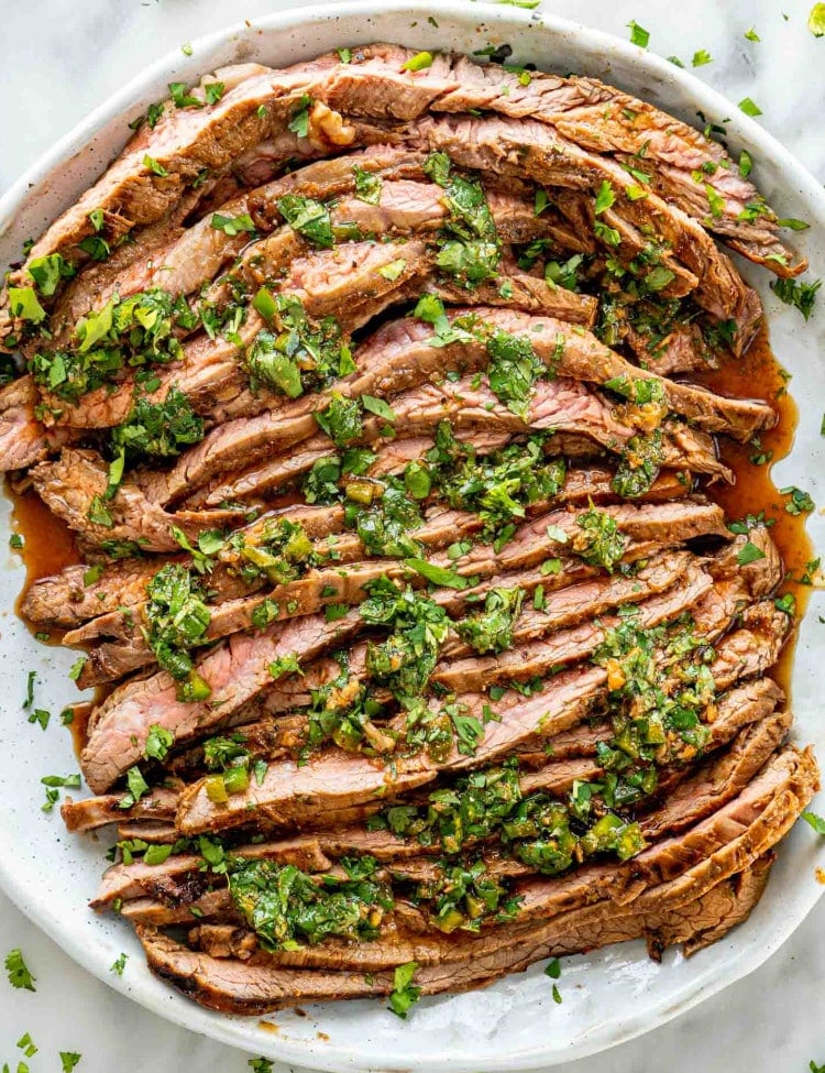 sliced carne asada on a plate.