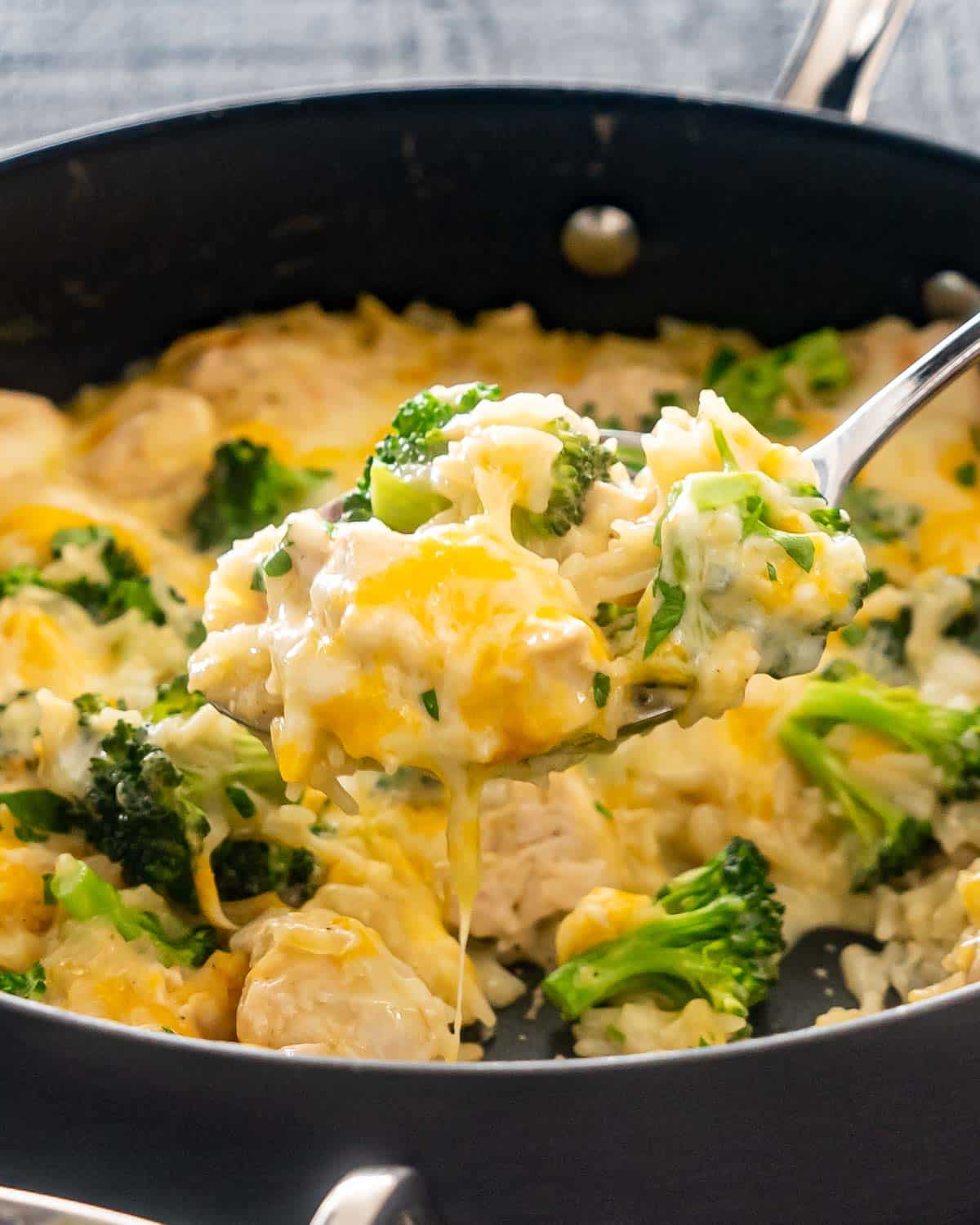freshly made cheesy chicken broccoli rice casserole in a skillet.