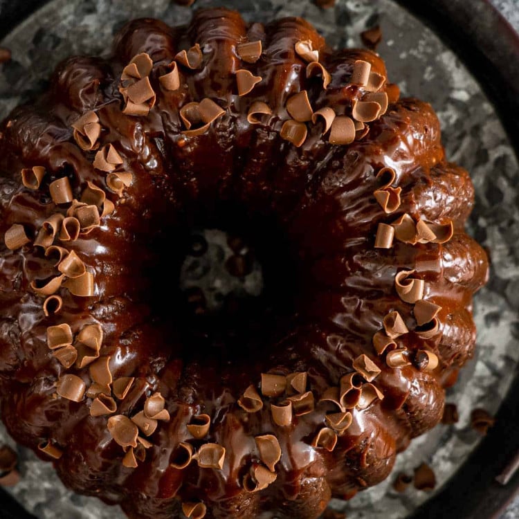 chocolate bundt cake topped with chocolate ganache and sprinkled with chocolate shavings.