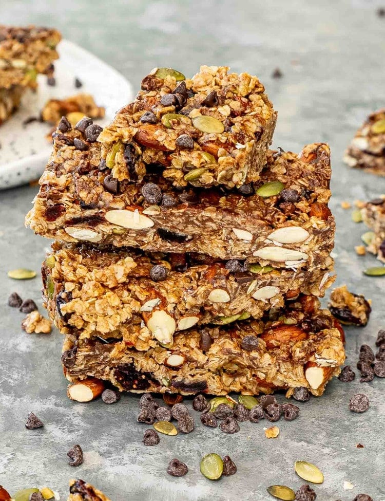 a few pieces of stacked granola bars on a gray surface.