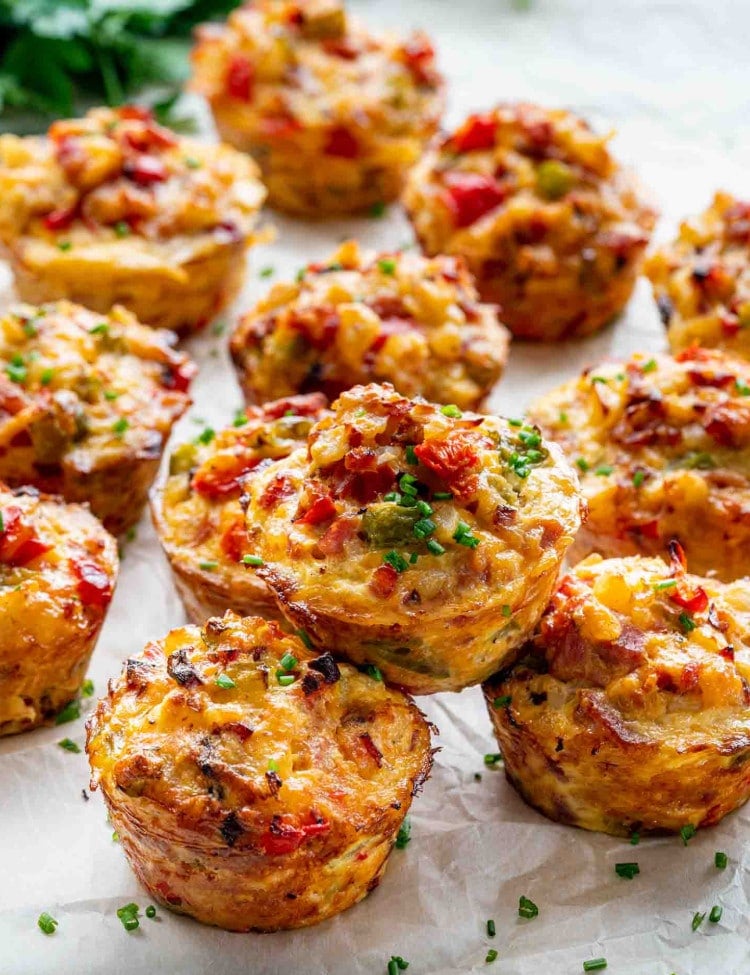 a few leftover ham and cheese breakfast muffins on a table garnished with some parsley.