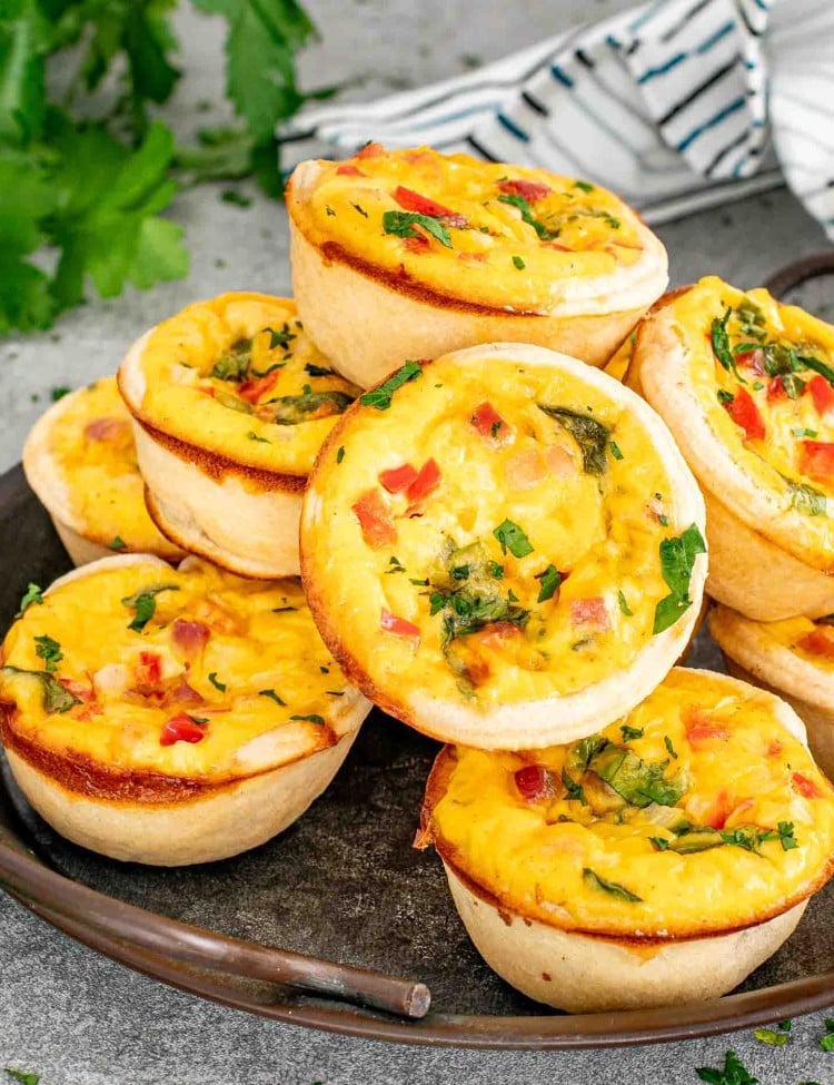 a plate full of freshly baked mini quiche.