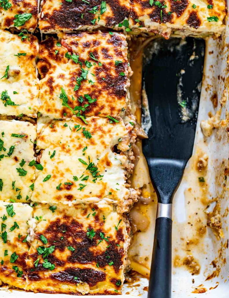 freshly baked moussaka in a white casserole dish.