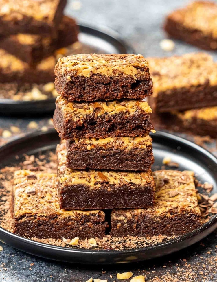 a stack of peanut butter brownies on a plate.