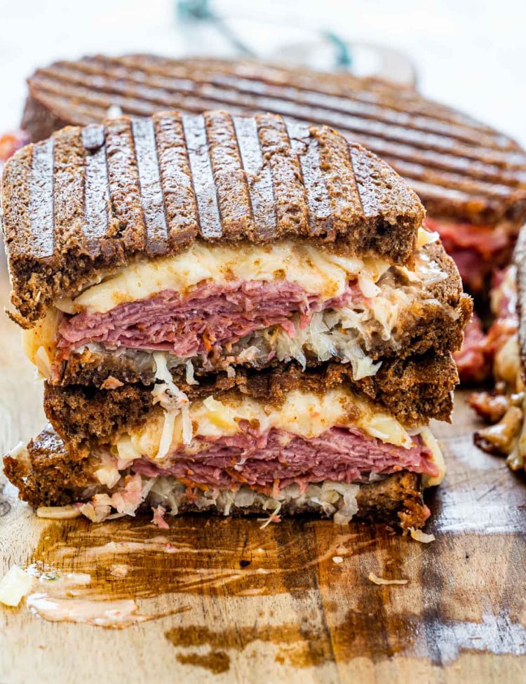 A reuben sandwich cut in half and stacked with the centers exposed