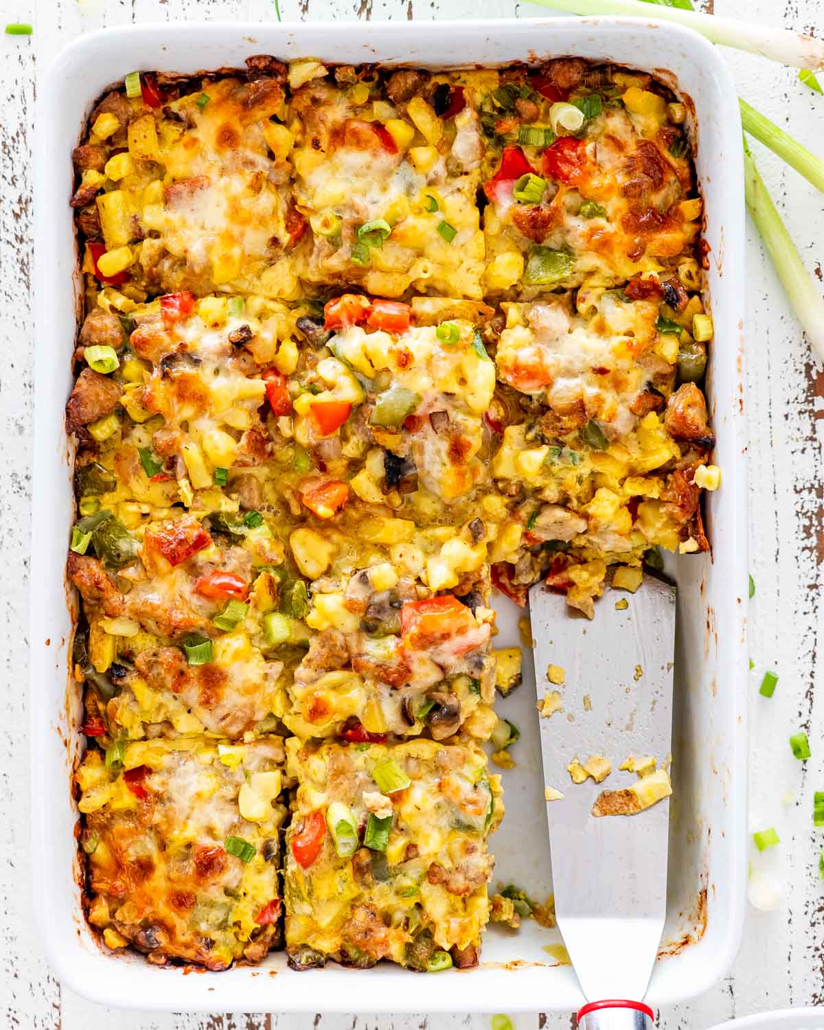 sausage potato breakfast casserole cut into slices with 2 slices missing.