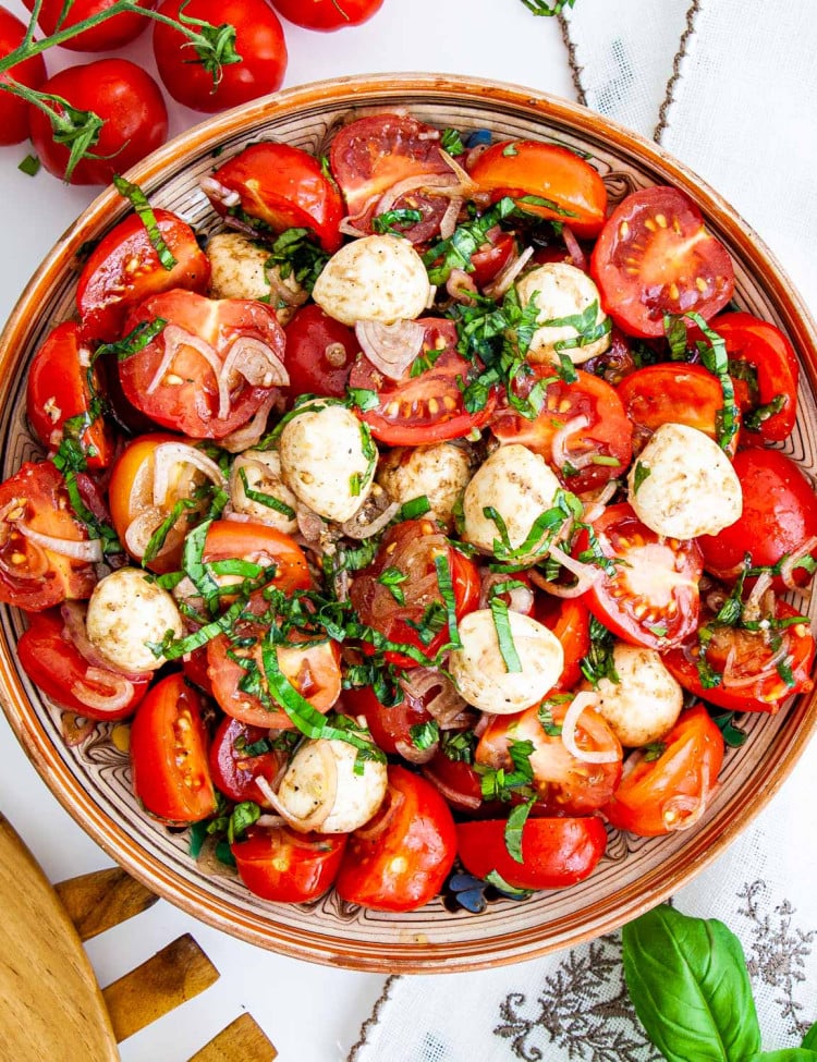 overhead shot of tomato basil salad with bocconcini in a bowl
