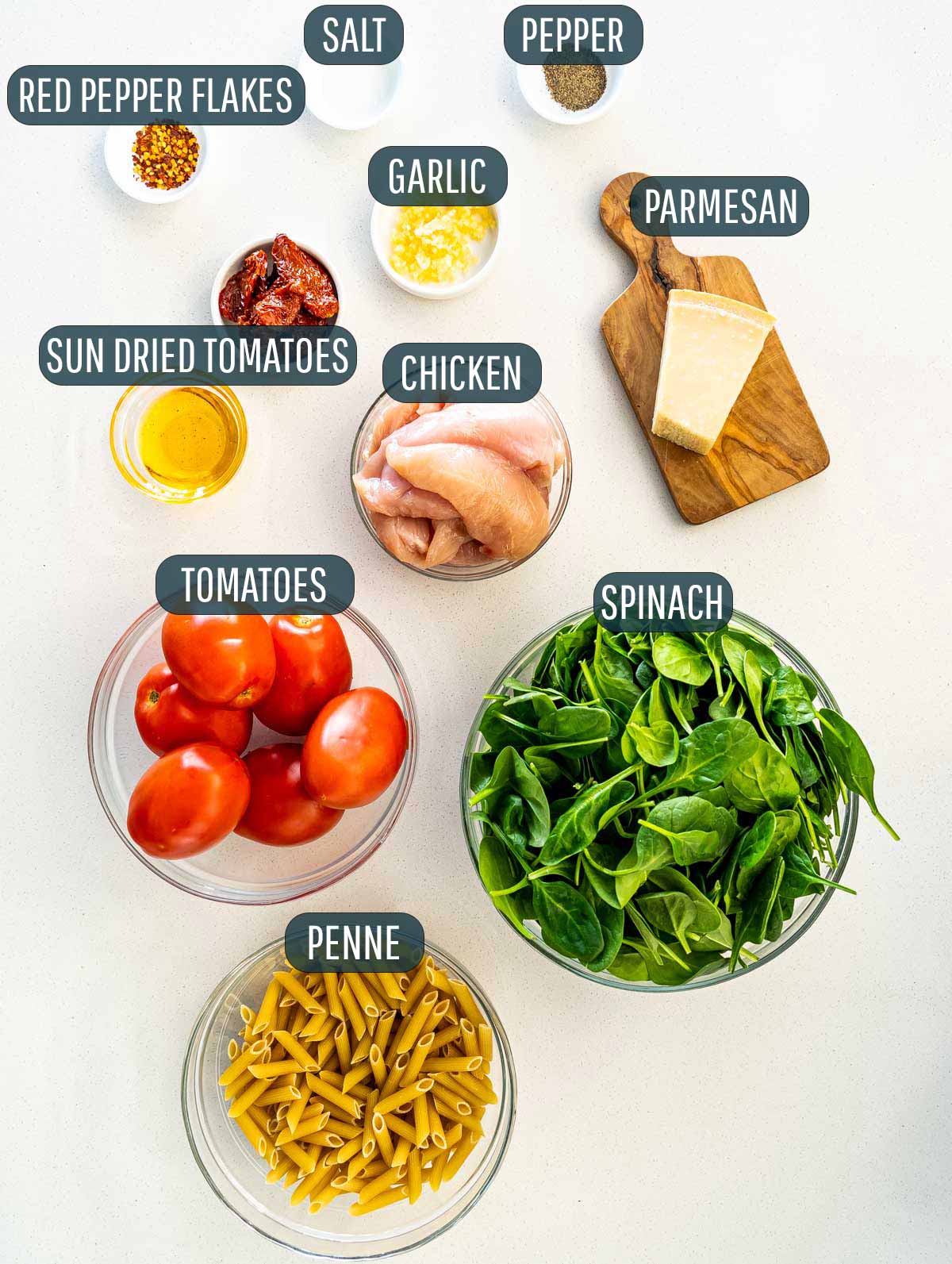 overhead shot of ingredients needed to make tomato spinach chicken pasta.